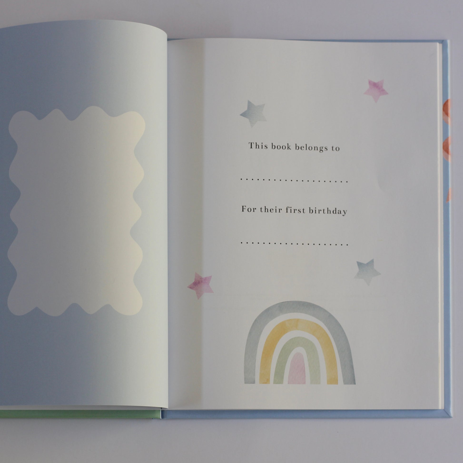 Open children's picture book Onederland with a rainbow and star design on a white background